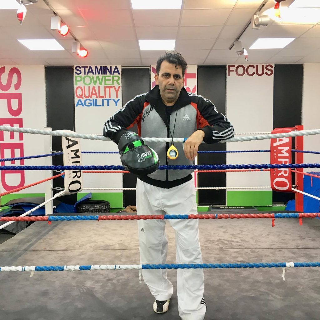 taekwondo classes london Master Sammy in boxing gloves standing inside a boxing ring