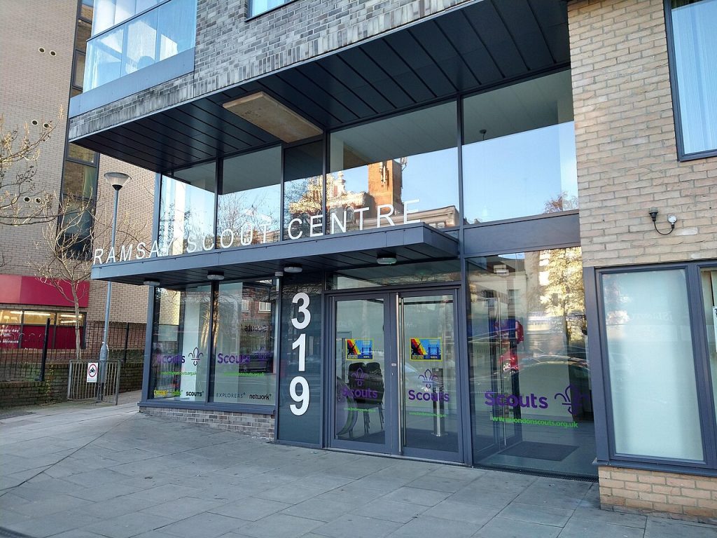 Entrance to Ramsay Scout Centre with large glass windows and the number 319. Holloway Road